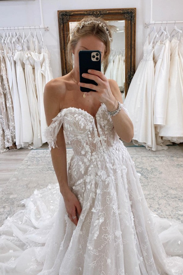 Vestido de novia encantador, largo, sin mangas, con encaje y corte en A, hombros descubiertos y cola de corte.
