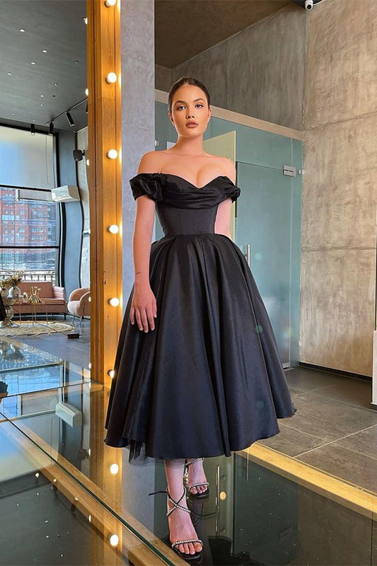 Vestido de fiesta negro elegante y deslumbrante con hombros descubiertos y volantes.
