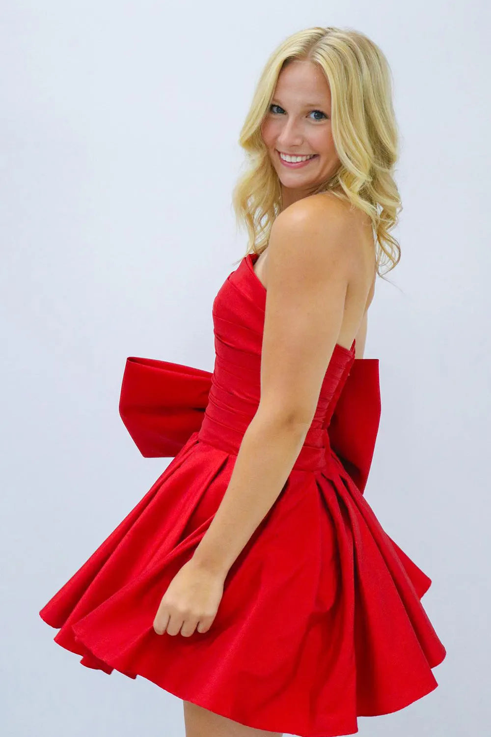Fern | A-Linien-Partykleid ohne Träger und mit Plissee und Schleife
