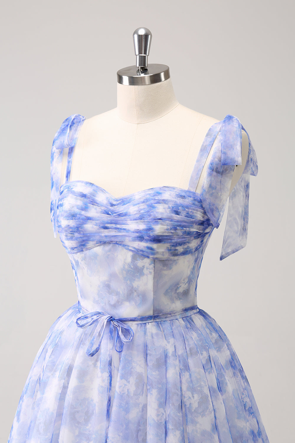 Hermoso vestido de fiesta azul de corte A con tirantes finos, plisado, corto y con cordones en la espalda.