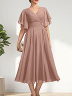 Vestido de gasa para madre de la novia con escote en V, corte A y largo hasta la rodilla, con cuentas plisadas