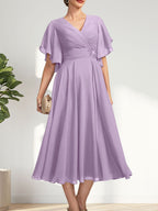 Vestido de gasa para madre de la novia con escote en V, corte A y largo hasta la rodilla, con cuentas plisadas