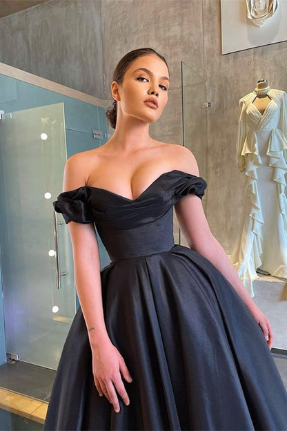 Vestido de fiesta negro elegante y deslumbrante con hombros descubiertos y volantes.