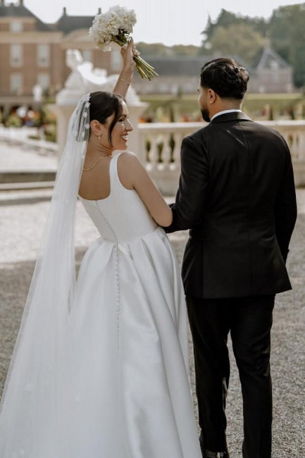Hermosos vestidos de novia blancos sin mangas, de satén, con hombros descubiertos y abertura frontal.