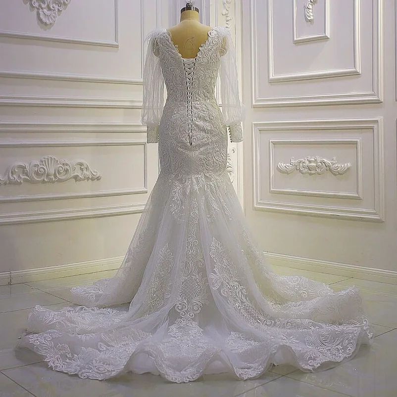 Hermoso vestido de novia de sirena con mangas largas y apliques de encaje y cola