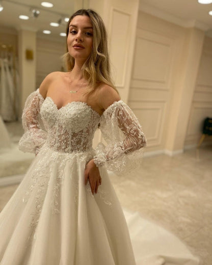 Hermosos vestidos de novia de corte A con hombros descubiertos y encaje
