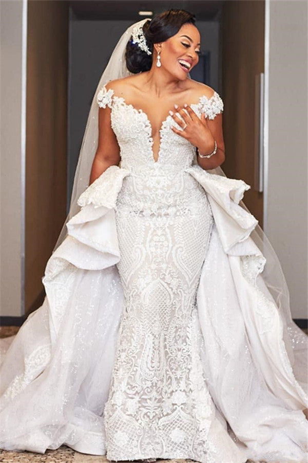 Vestido de novia largo estilo sirena con mangas cortas y sobrefalda con volantes
