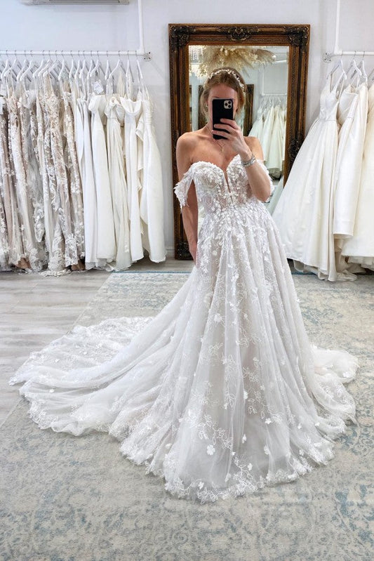 Vestido de novia encantador, largo, sin mangas, con encaje y corte en A, hombros descubiertos y cola de corte.
