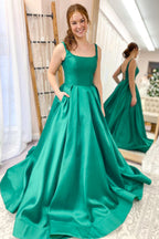 Vestido de fiesta elegante, largo, de satén, con tirantes finos, espalda descubierta y bolsillos.