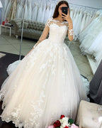 Vestido de novia elegante de tul con encaje, apliques de princesa y mangas largas