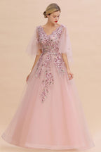 Elegante vestido de novia de tul con corte en A y flores, con mangas largas abullonadas y vestido de fiesta de noche.