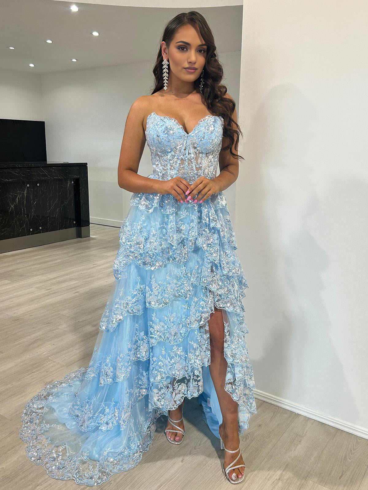 Vestido de fiesta largo azul claro sin tirantes, con volantes y abertura en capas