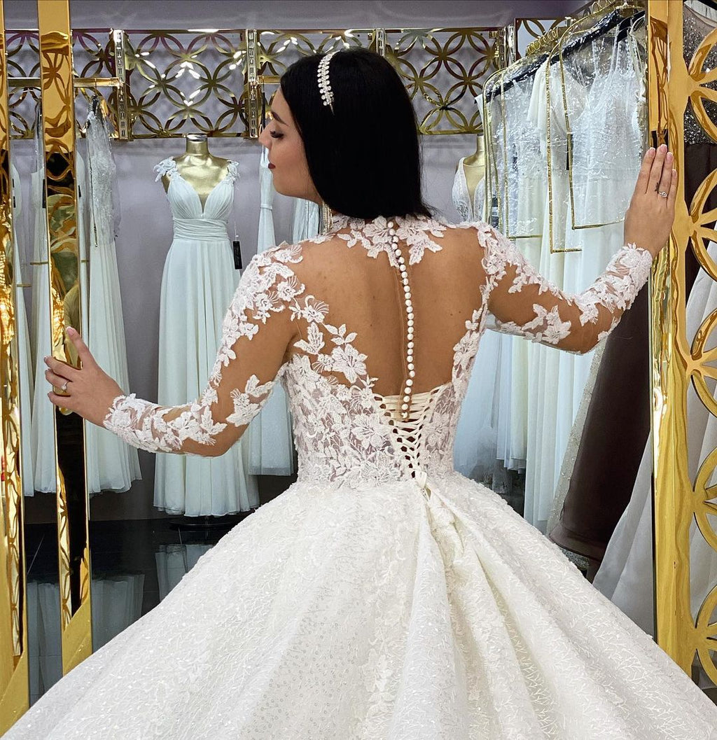 Wunderschönes langes Prinzessinnen-Brautkleid mit hohem Halsausschnitt, Spitzenapplikationen und Ärmeln