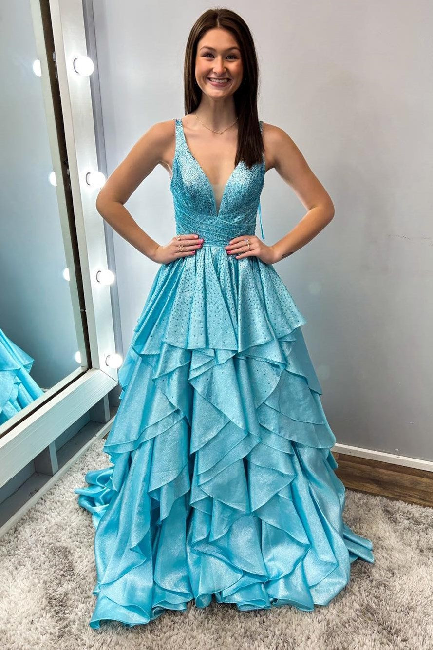 Vestido de fiesta largo con volantes multicapa en color azul agua con piedras calientes de nácar