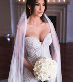 Vestido de novia de sirena con apliques de tul y escote corazón sin tirantes y cuentas