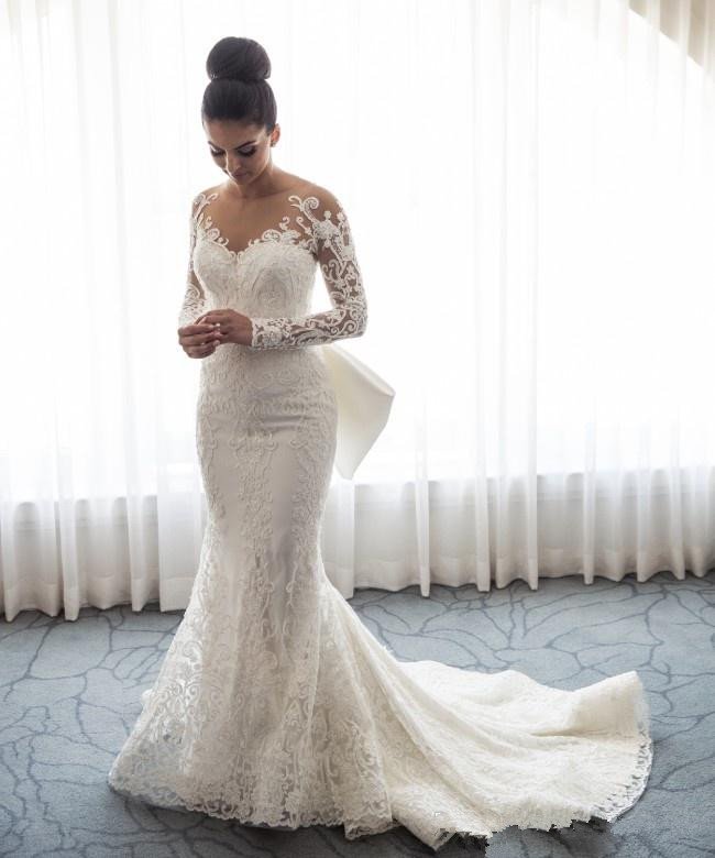 Impresionante vestido de novia de sirena con encaje y lazo, con falda desmontable y mangas largas.